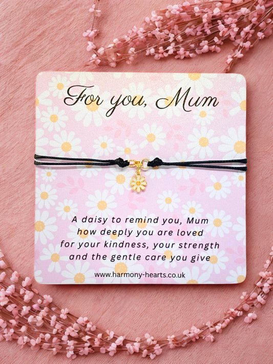 Daisy Charm Bracelet with a message card for 'Mum' on a pink floral background