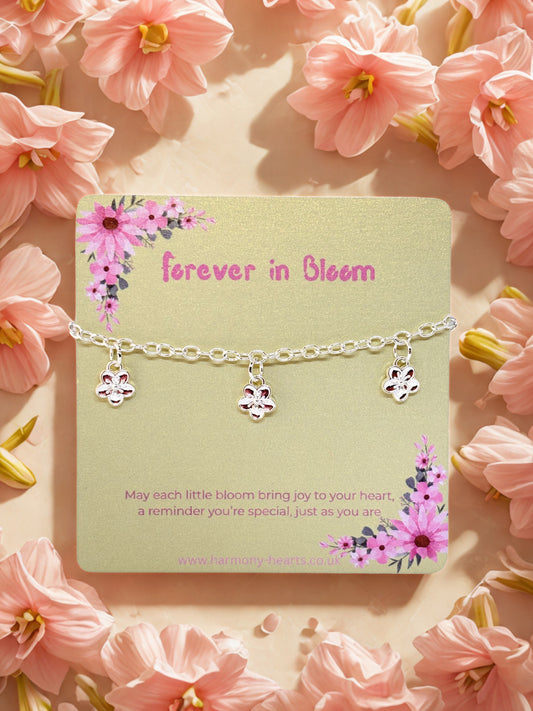 Silver charm bracelet with flower charms presented on a Harmony Hearts poem card