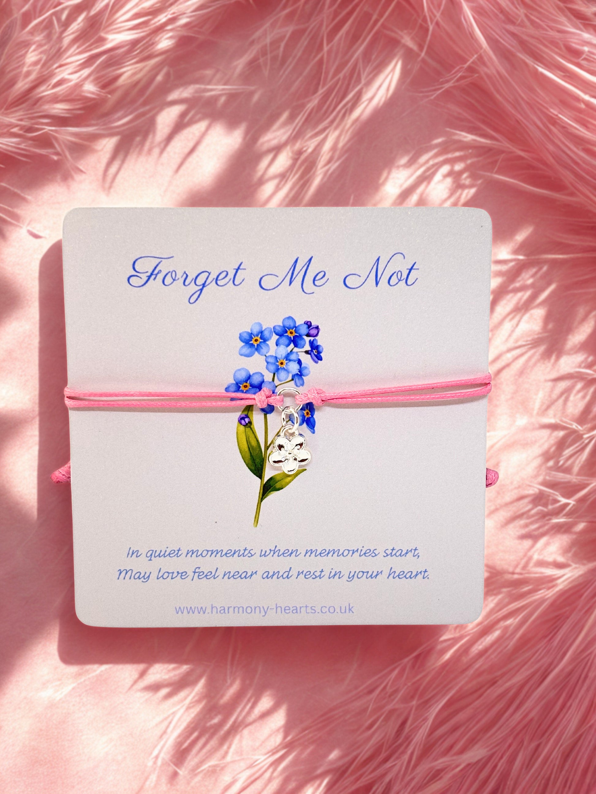 Branded card by Harmony Hearts with pink cord charm bracelet with flower charm