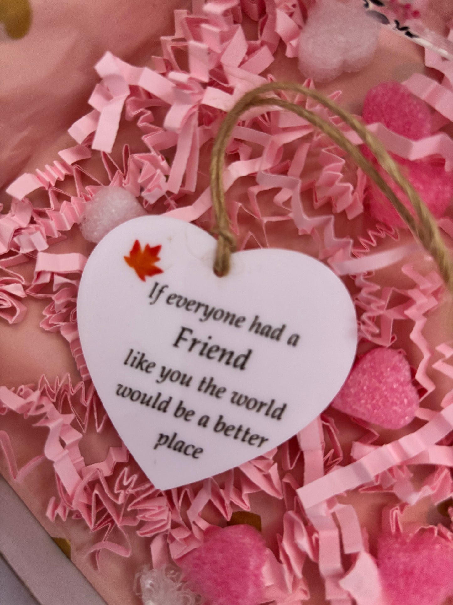 Heart-shaped tag with a message on a pink textured background
