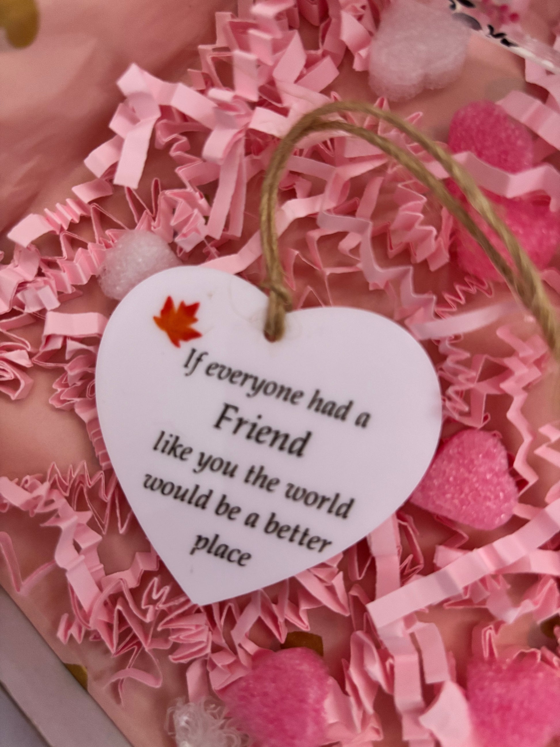 Heart-shaped tag with a message on a pink textured background
