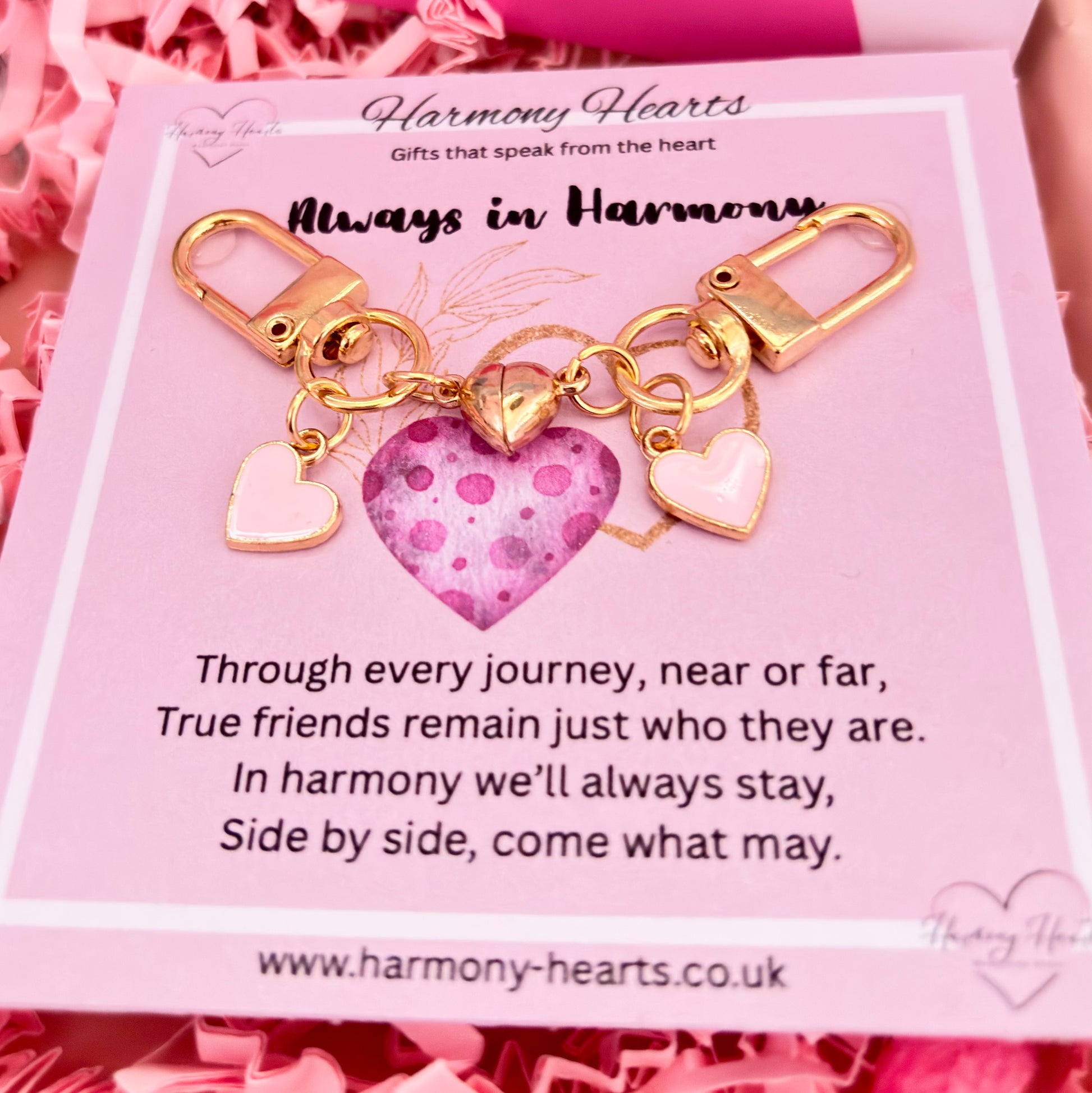 Gold keychain with heart charm on a pink card from Harmony Hearts