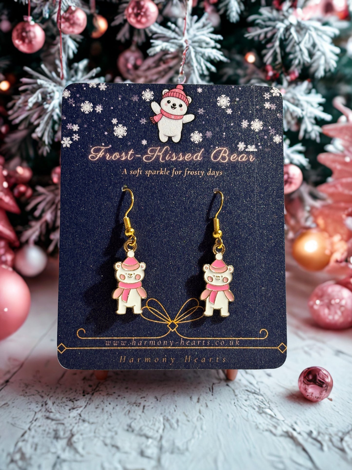 Frost Kissed Bear earrings on a card with Christmas decorations in the background