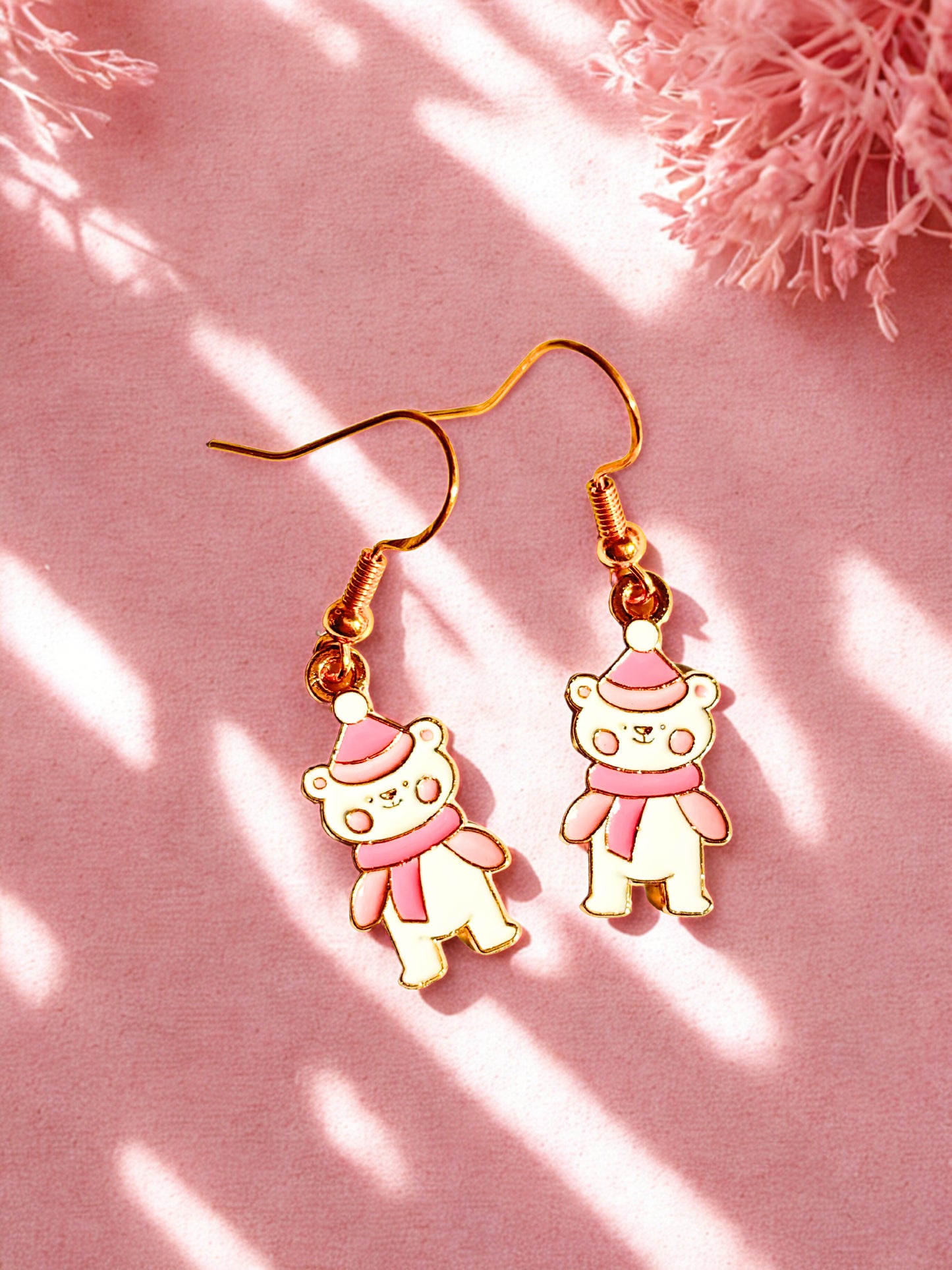 Winter bear Christmas earrings on a pink background
