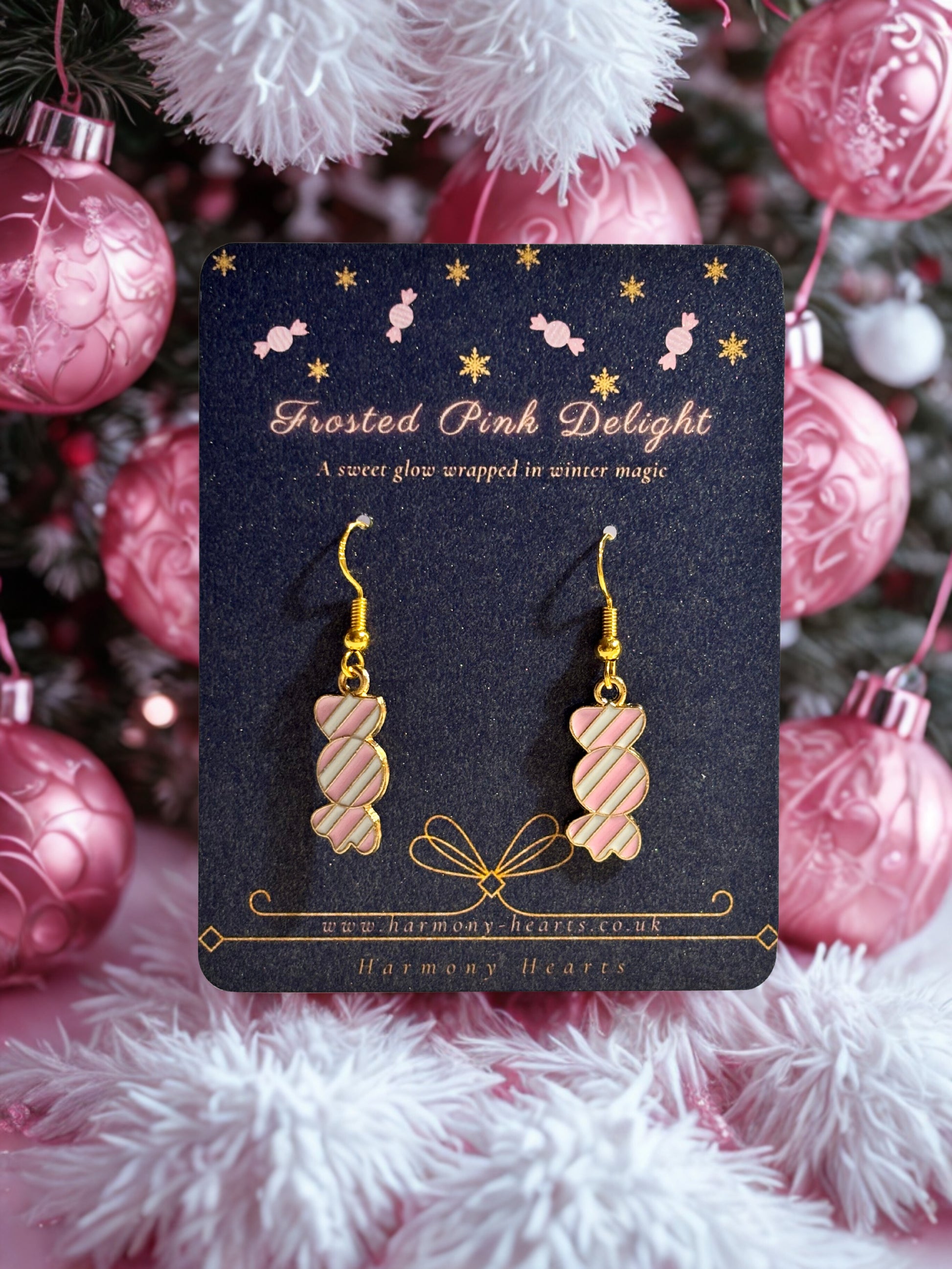 Frosted pink delight sweet earrings on a decorative card with Christmas ornaments in the background