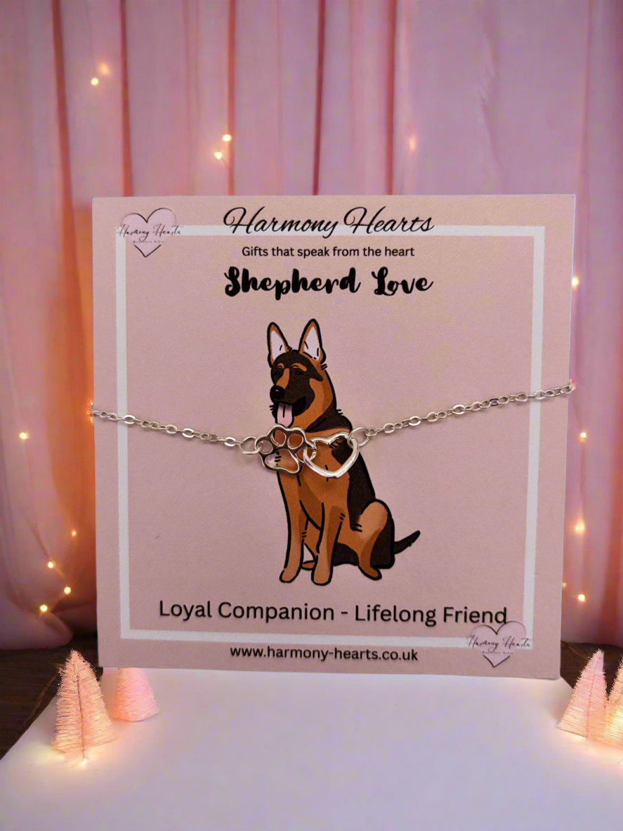 Dog-themed bracelet on a card with 'Harmony Hearts' branding, set against a soft pink background.