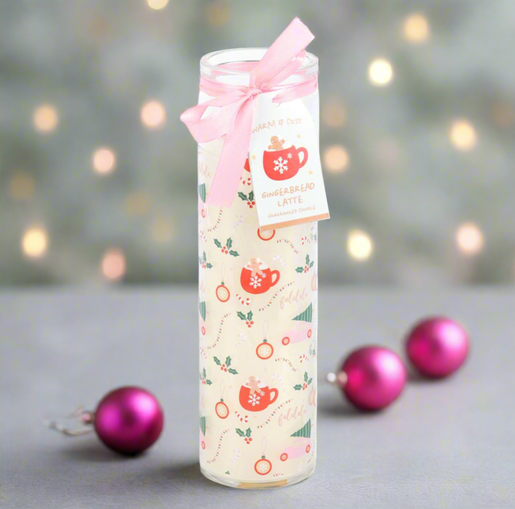 Gift candle with festive design and pink bow on a blurred background with Christmas ornaments.
