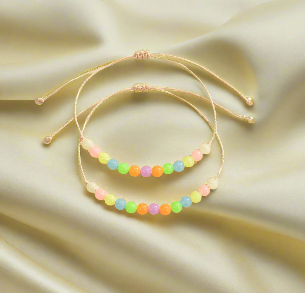 Set of colorful beaded bracelets on a satin surface