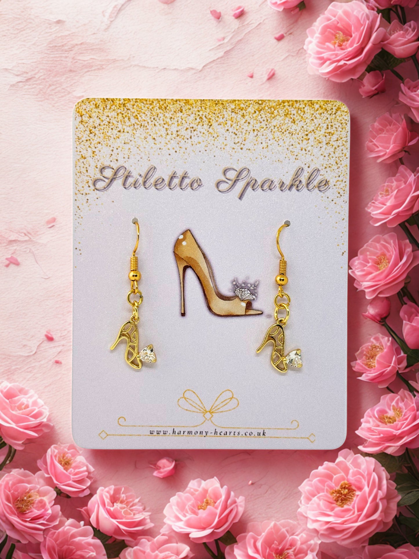 Gold high-heeled shoe earrings on a 'Stiletto Sparkle' card with pink roses around.