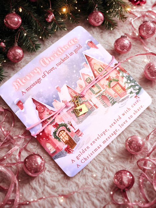 Decorative Christmas poem card with pink houses and an envelope charm bracelet on a festive background