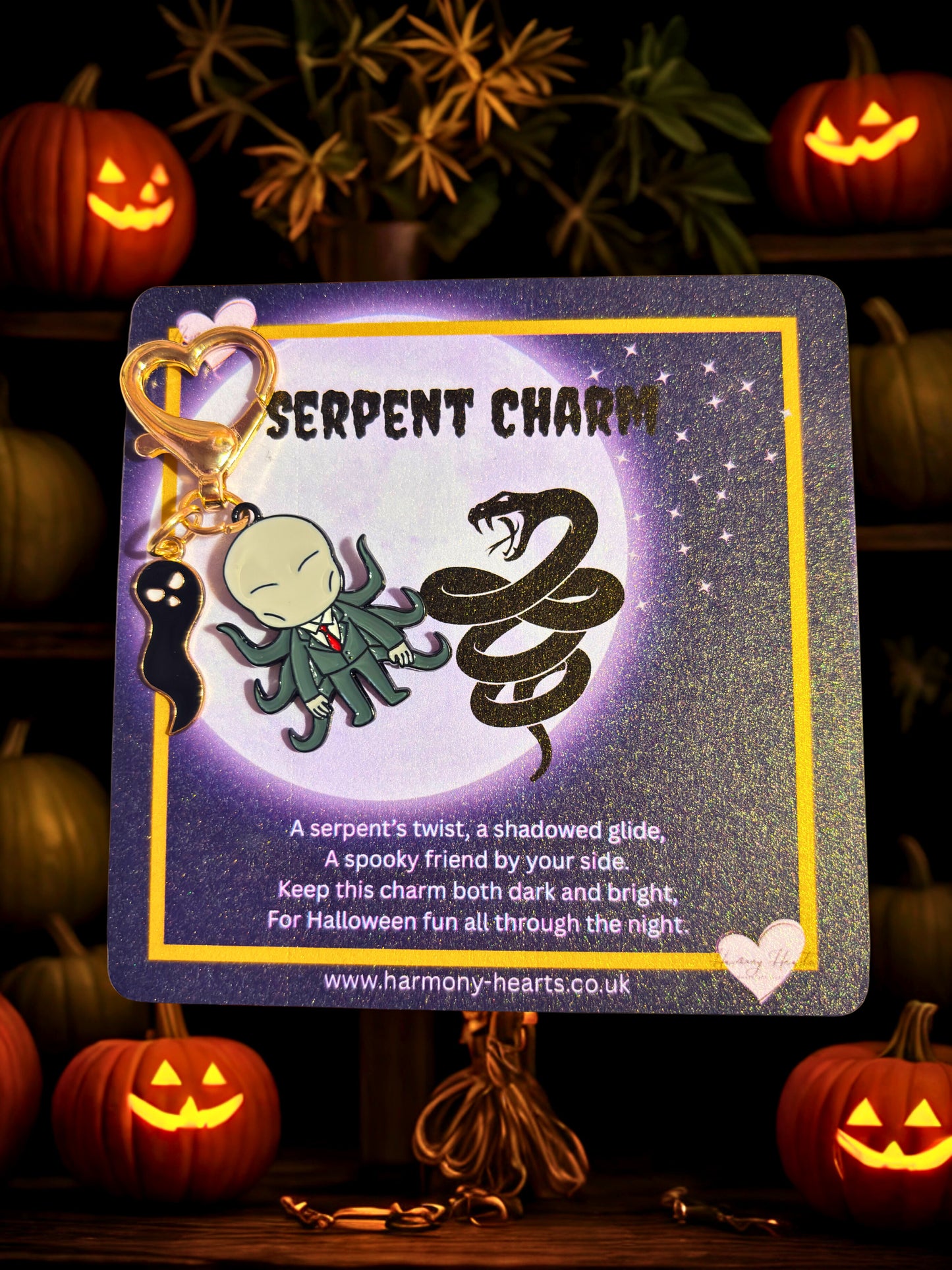 Serpent charm on a card with Halloween-themed background