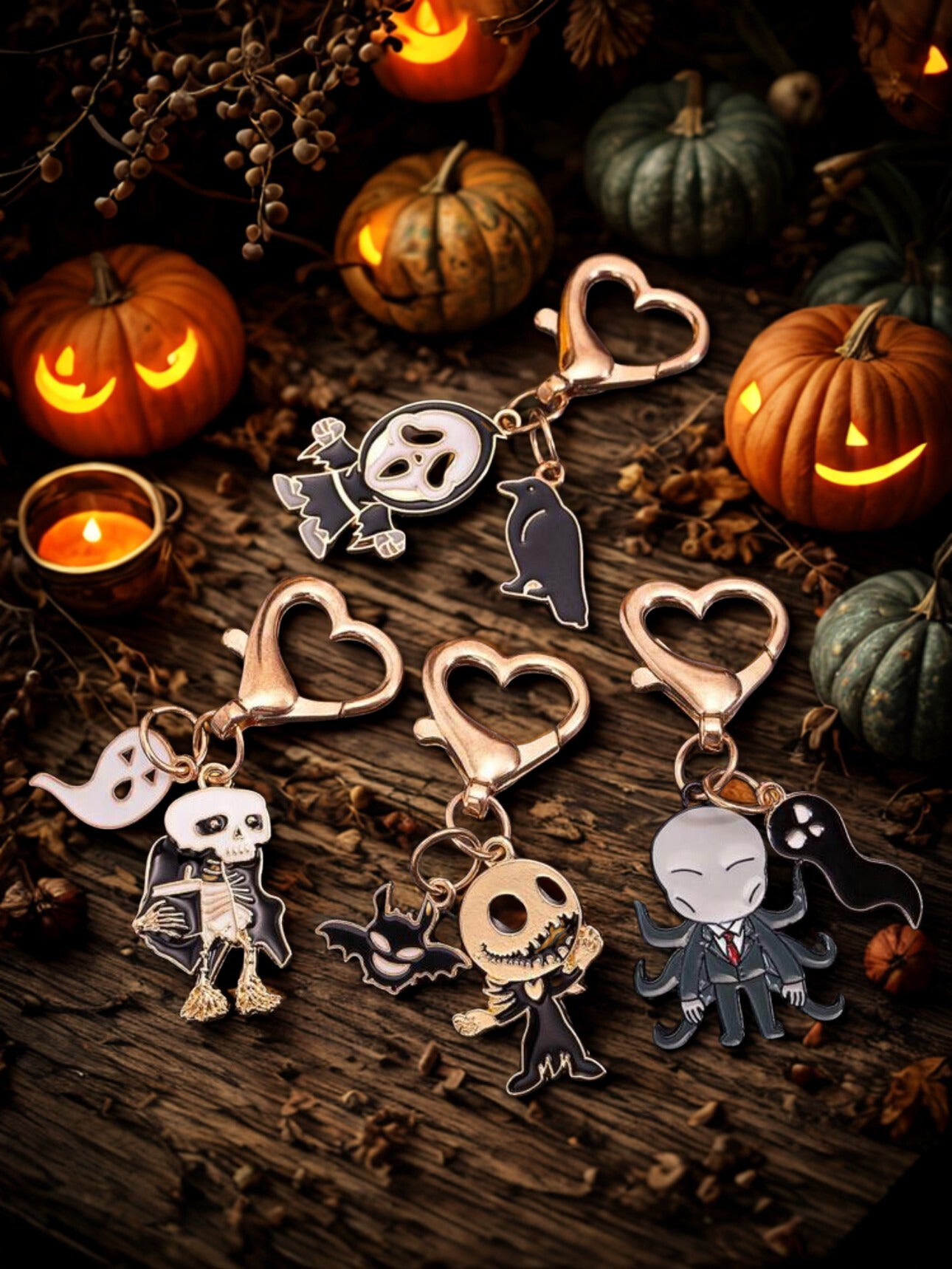 Halloween-themed keychains on a wooden surface with pumpkins and candles in the background