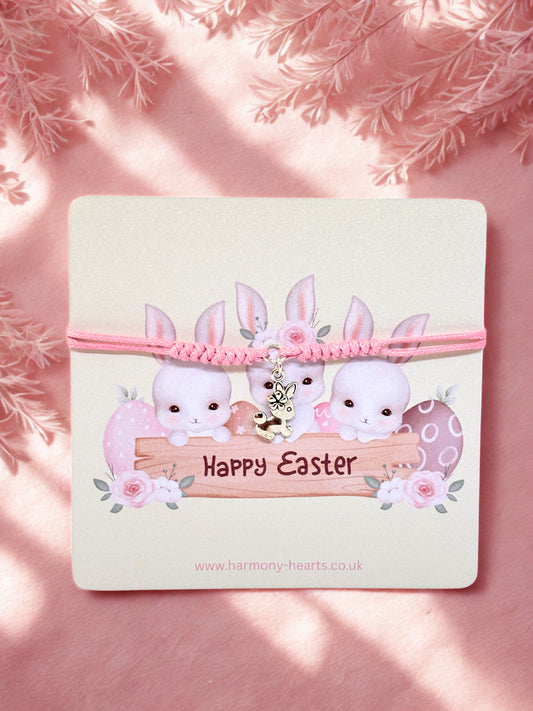 Pink bunny charm bracelet with 'Happy Easter' card on a pink background