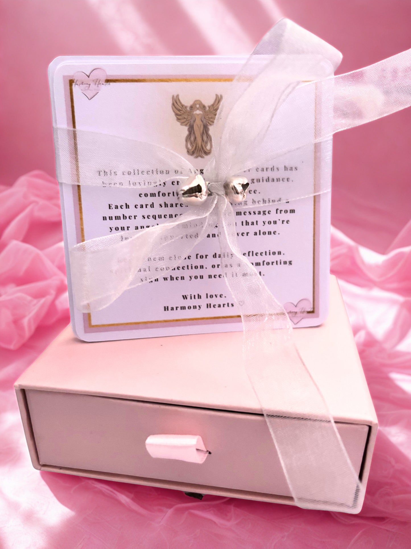 Set of angel number cards tied with a ribbon and bells on a keepsake box