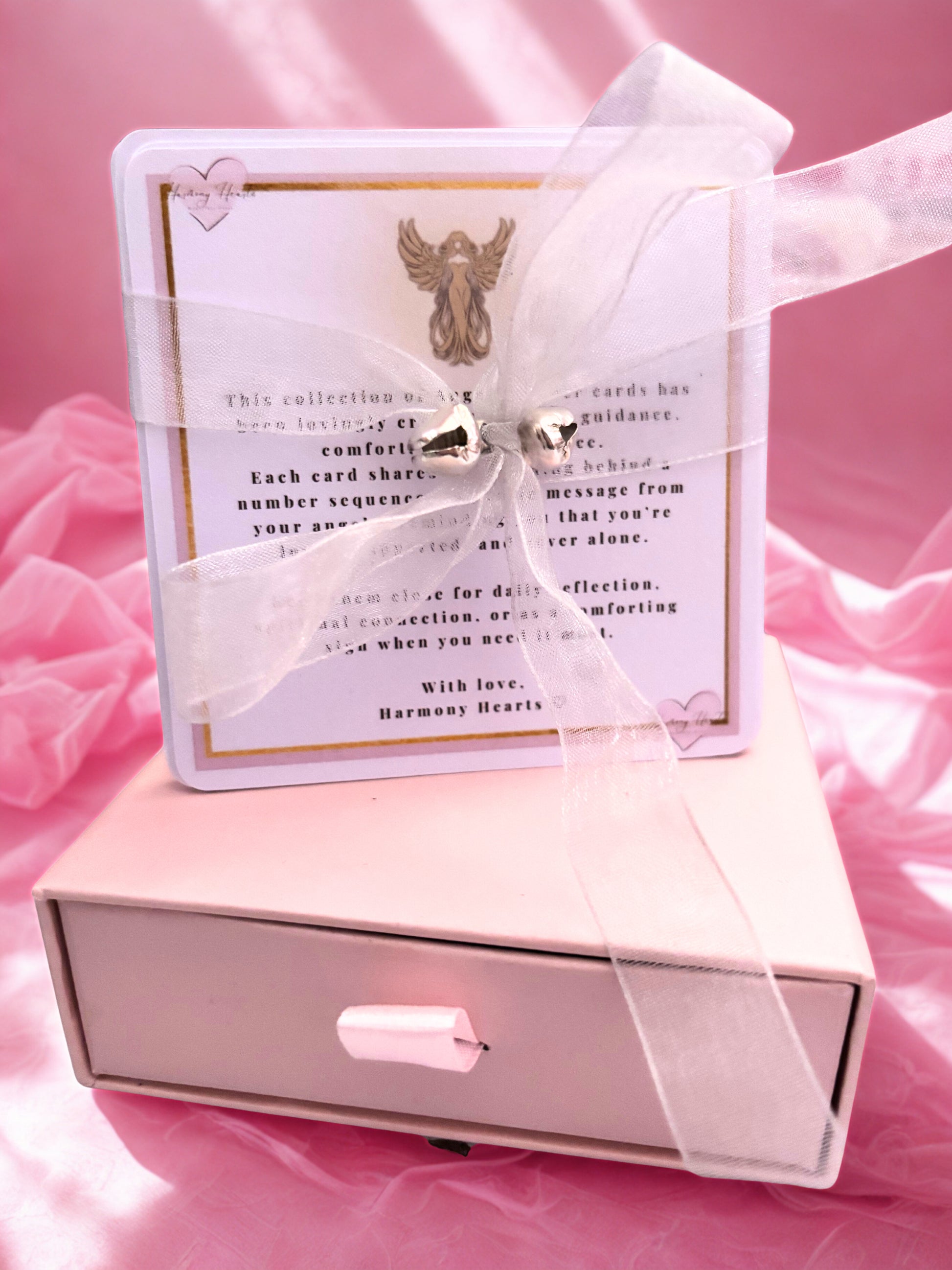 Set of angel number cards tied with a ribbon and bells on a keepsake box