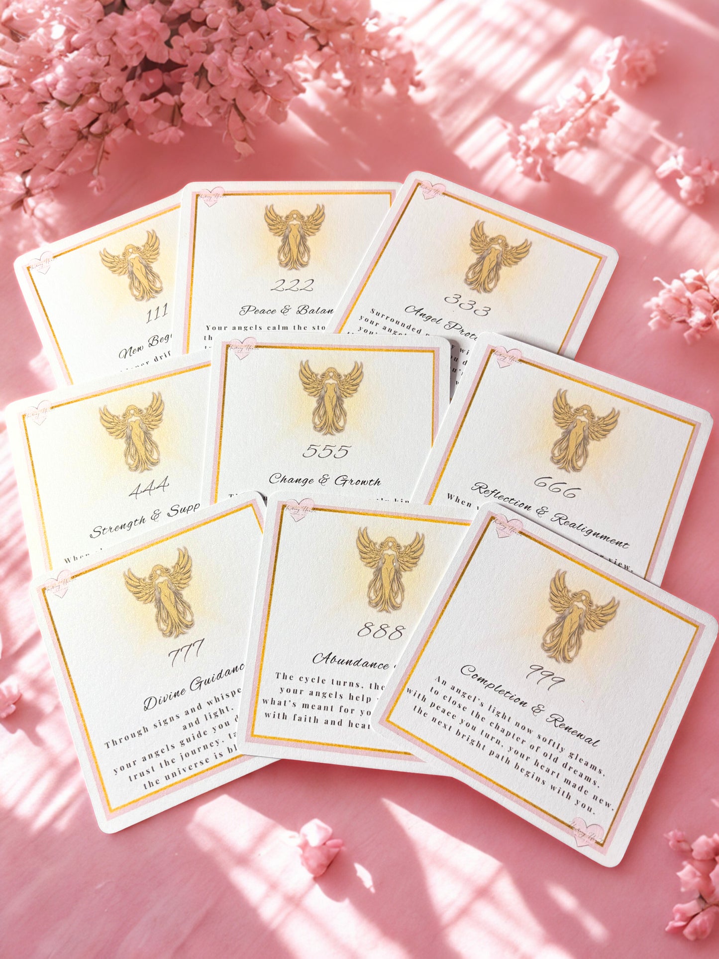 Set of angel number cards with angel illustrations on a pink background with flowers.