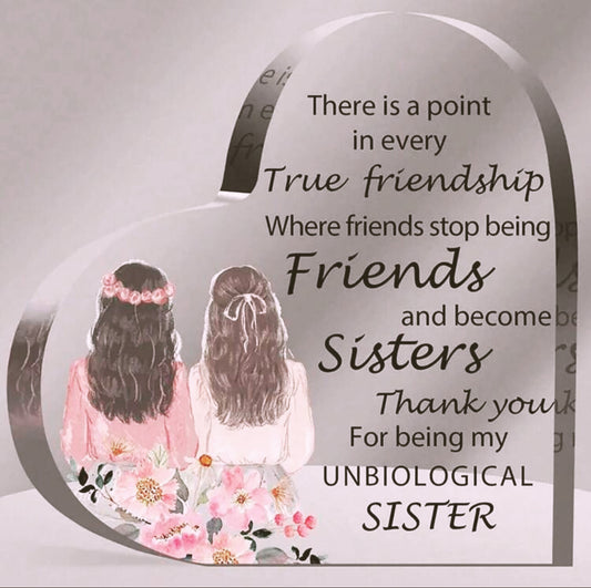 Decorative plaque with two women, floral elements, and a quote about friendship and sisterhood.