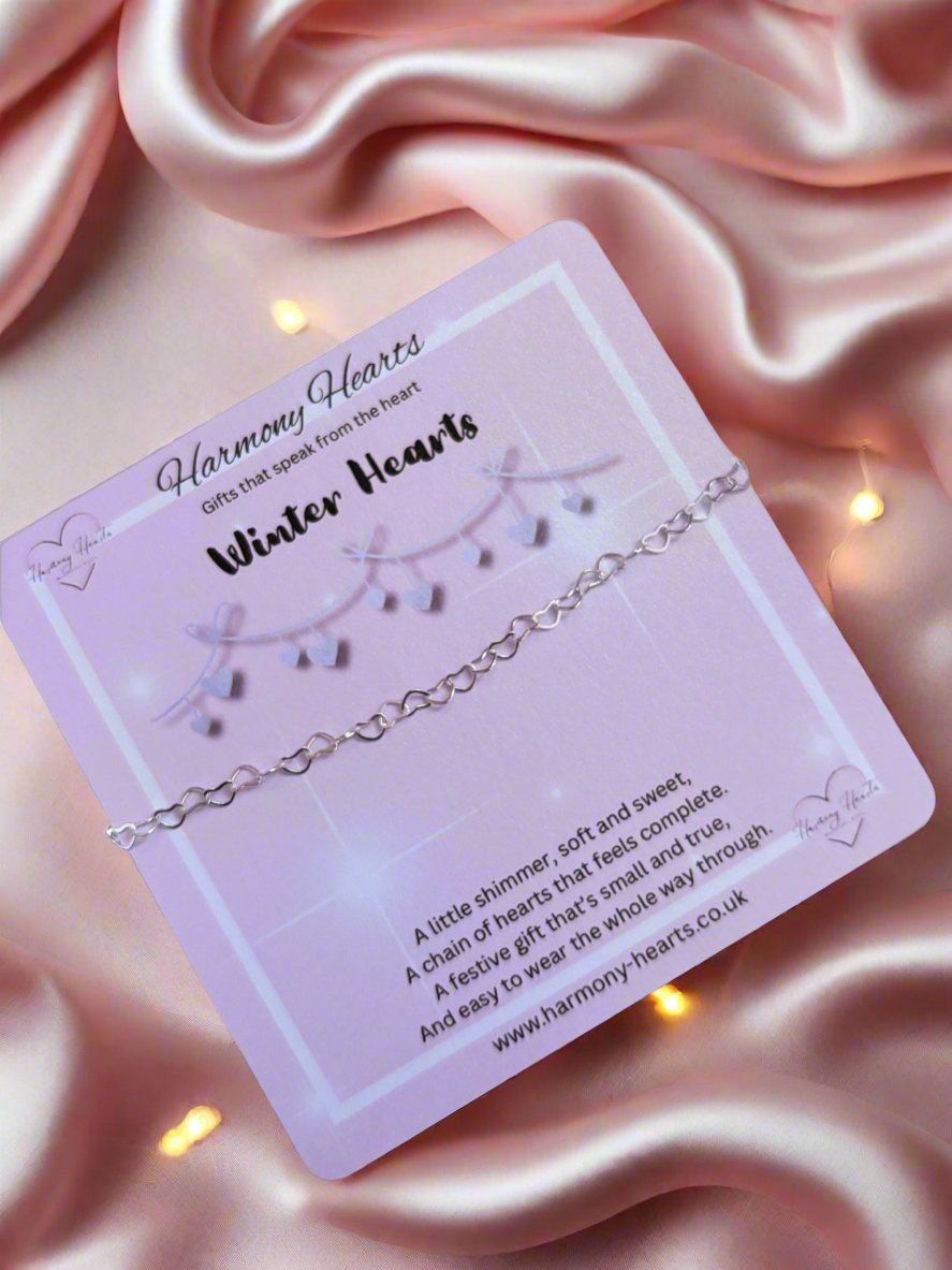 Silver bracelet on a 'Harmony Hearts' branded card with pink satin background