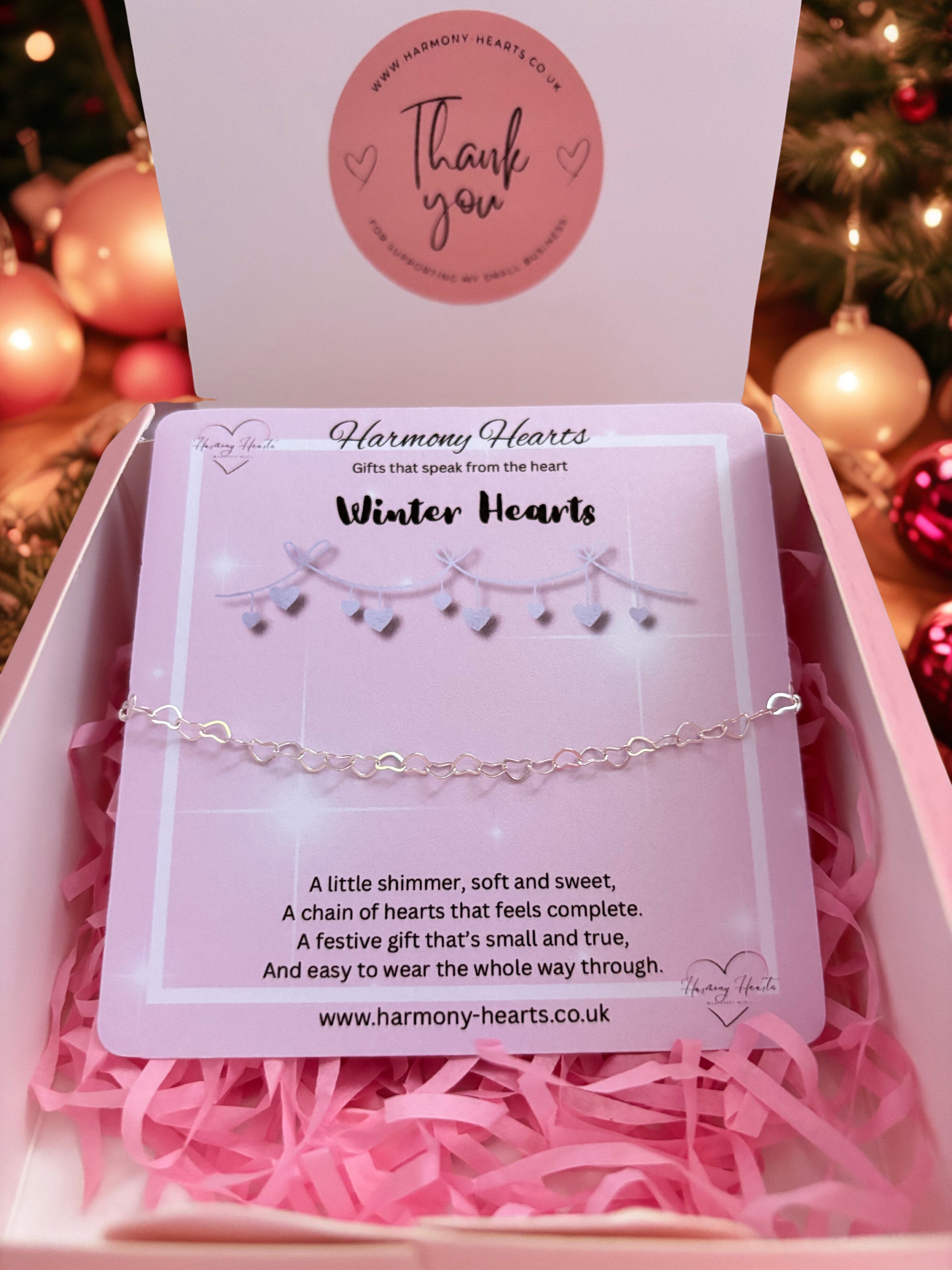 Silver chain bracelet in a 'Harmony Hearts' box with festive background