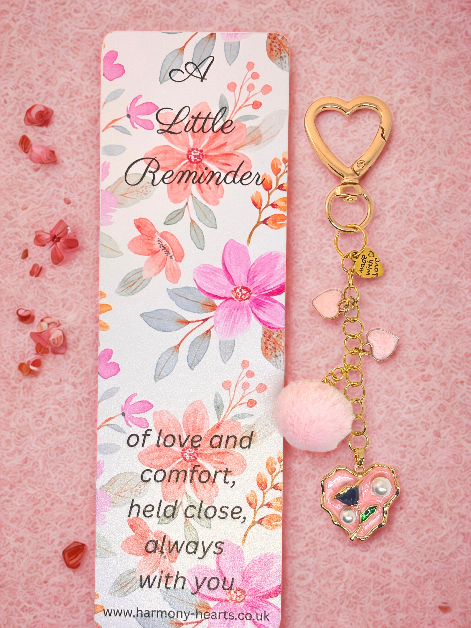 Floral keychain bag charm with decorative keychain on a pink background