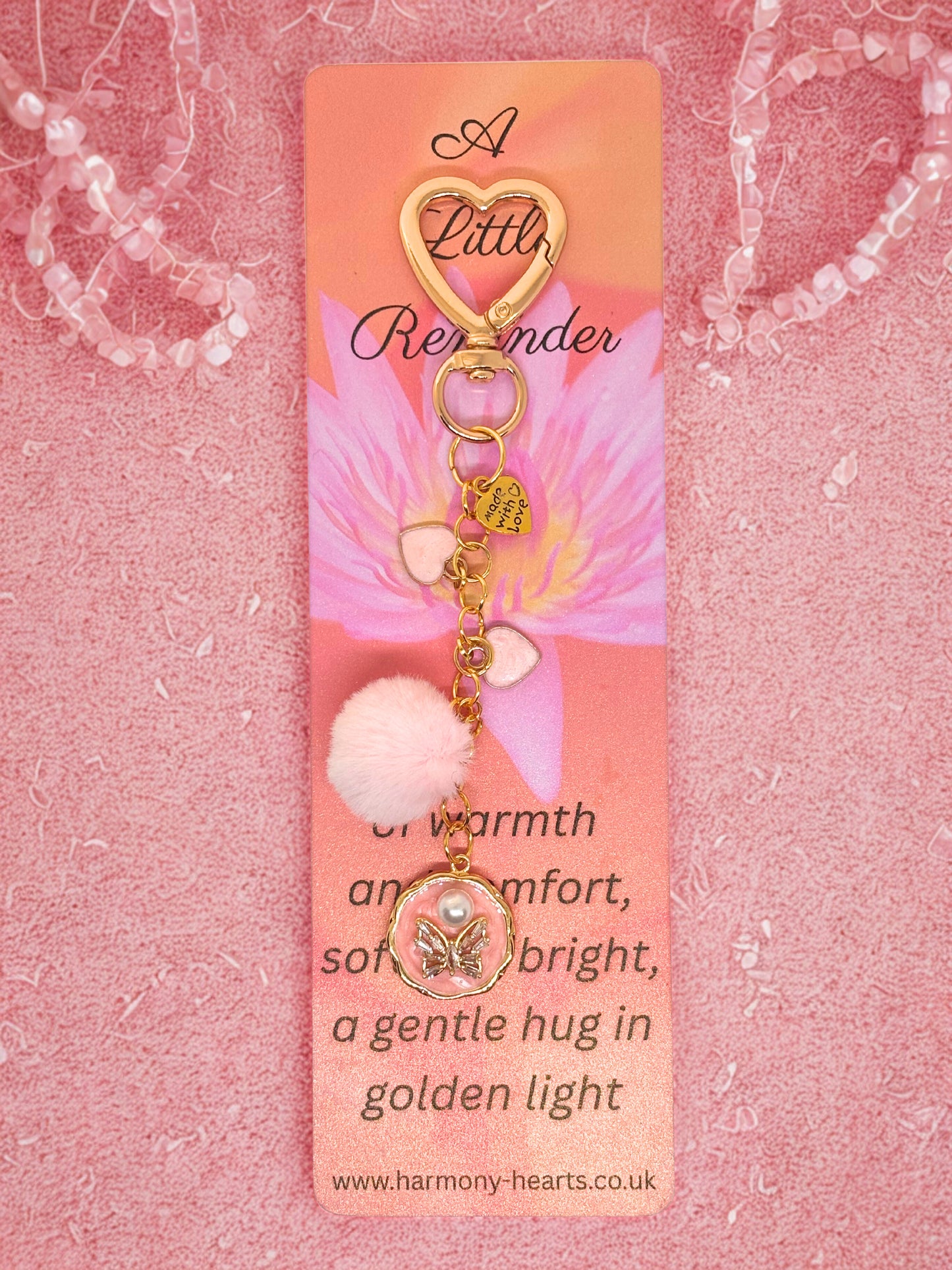 Keychain bag charm with heart design on a pink background