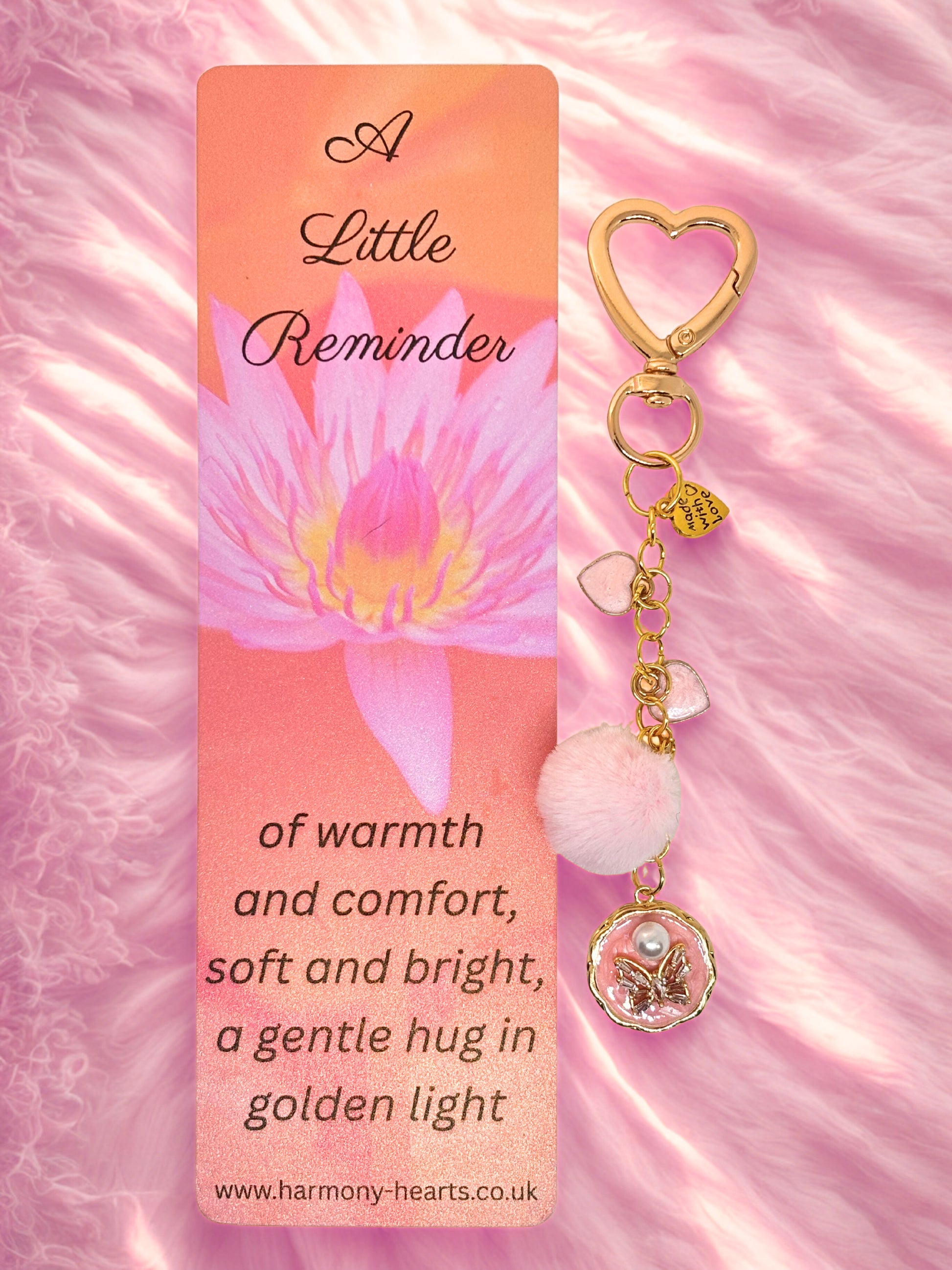 Keychain bag charm with heart design and pink flower on a pink background