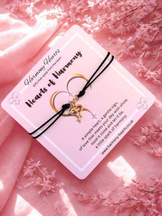 Bracelet with heart charm on a pink floral background