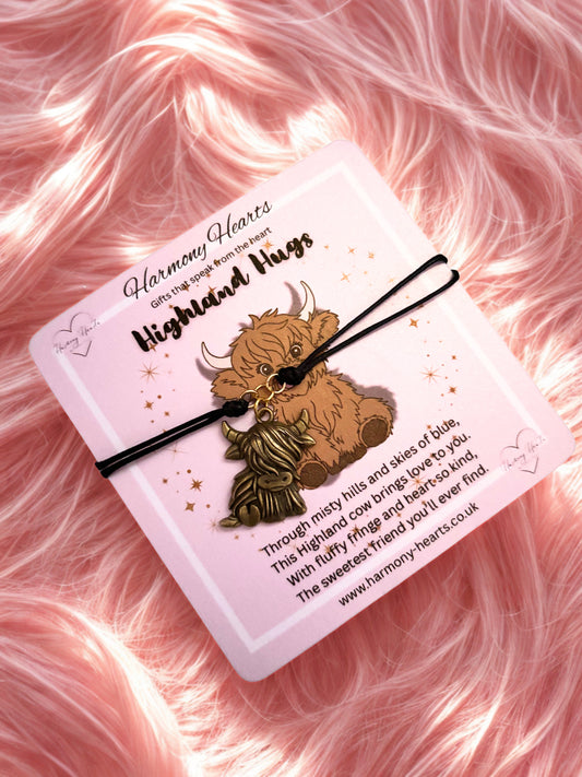 Harmony Hearts Highland Cow Hugs Bracelet  on a pink fluffy background