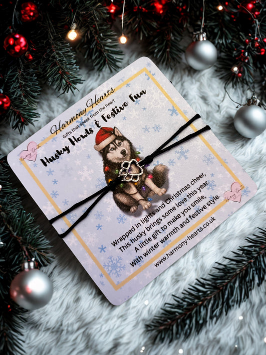Gift card with a husky design and bracelet on a festive background with Christmas decorations.