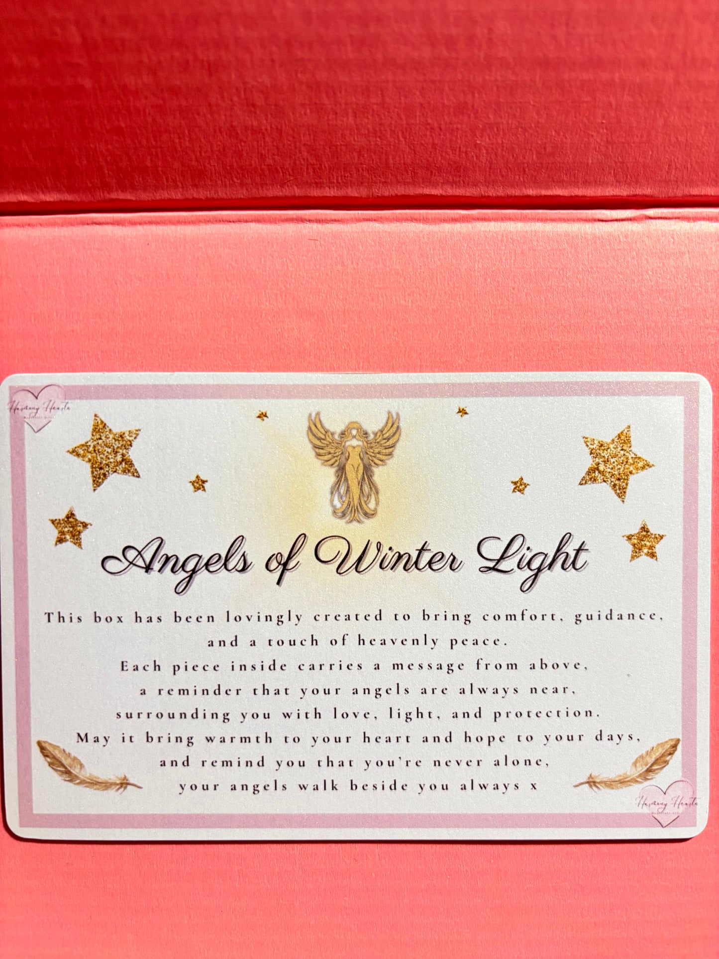 Card with 'Angels of Winter Light' text and decorative stars on a pink background