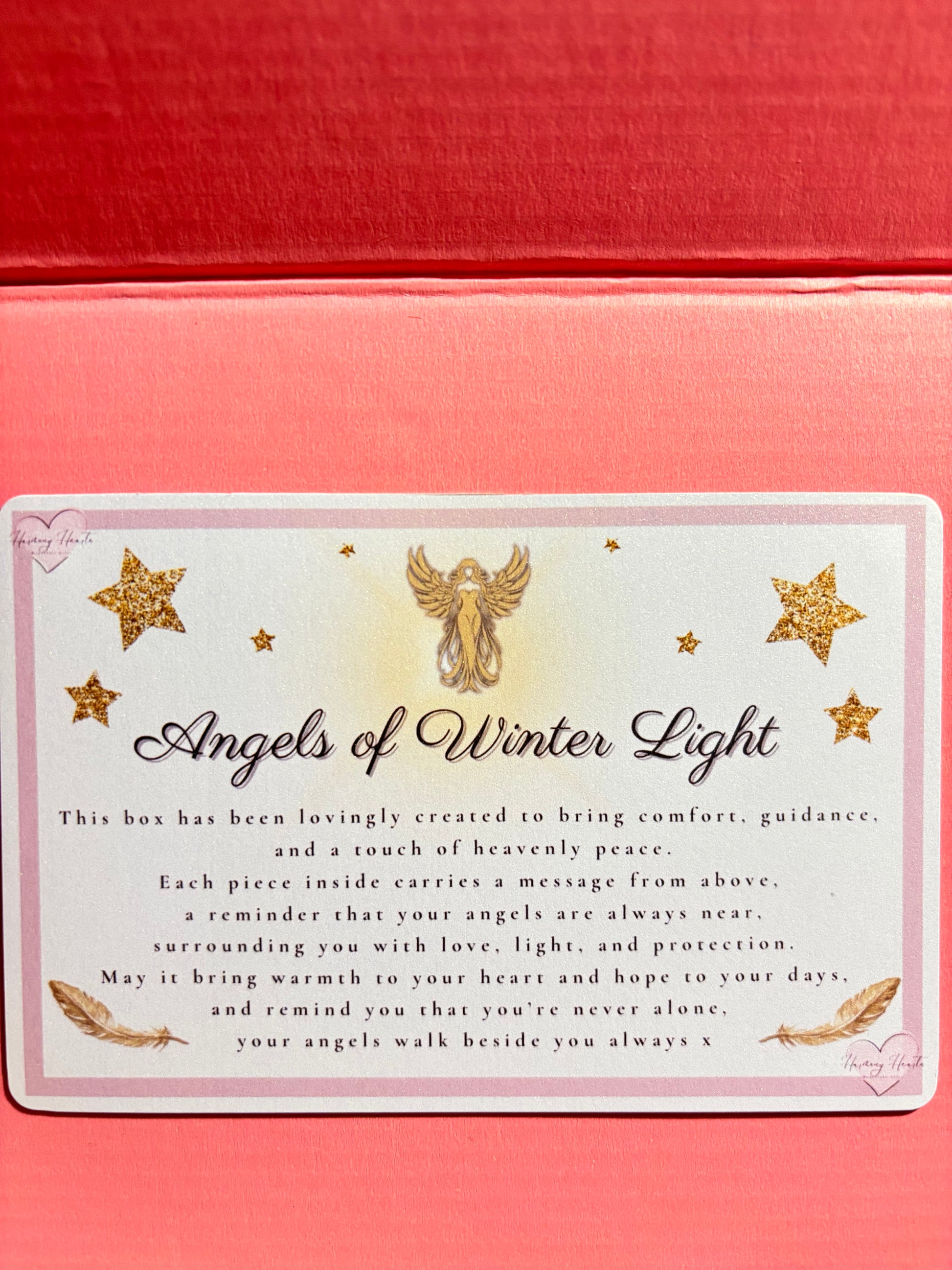 Card with 'Angels of Winter Light' text and decorative stars on a pink background