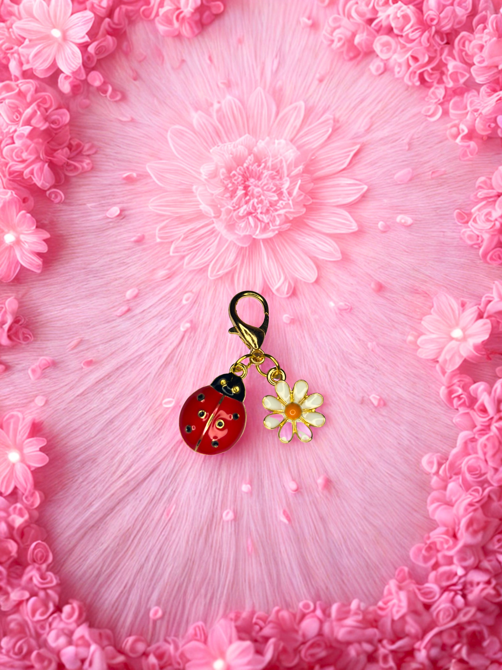 Keychain with a ladybug and flower charm on a pink floral background