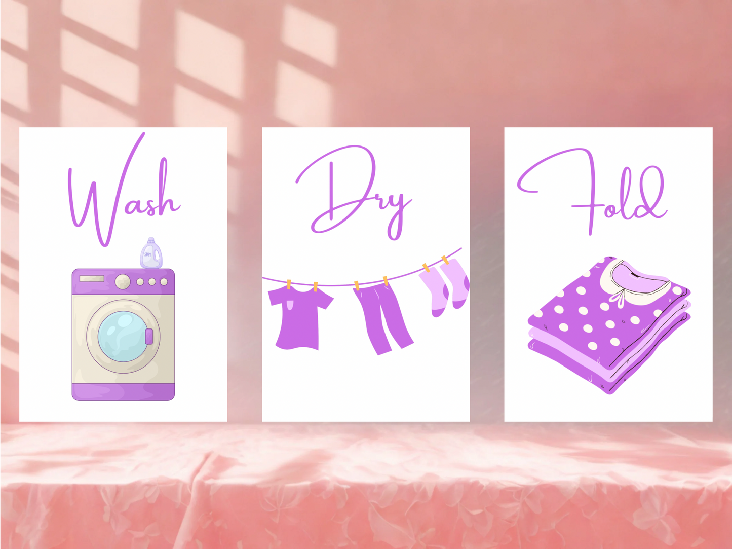 Three laundry-themed wall art prints on a pink wall.