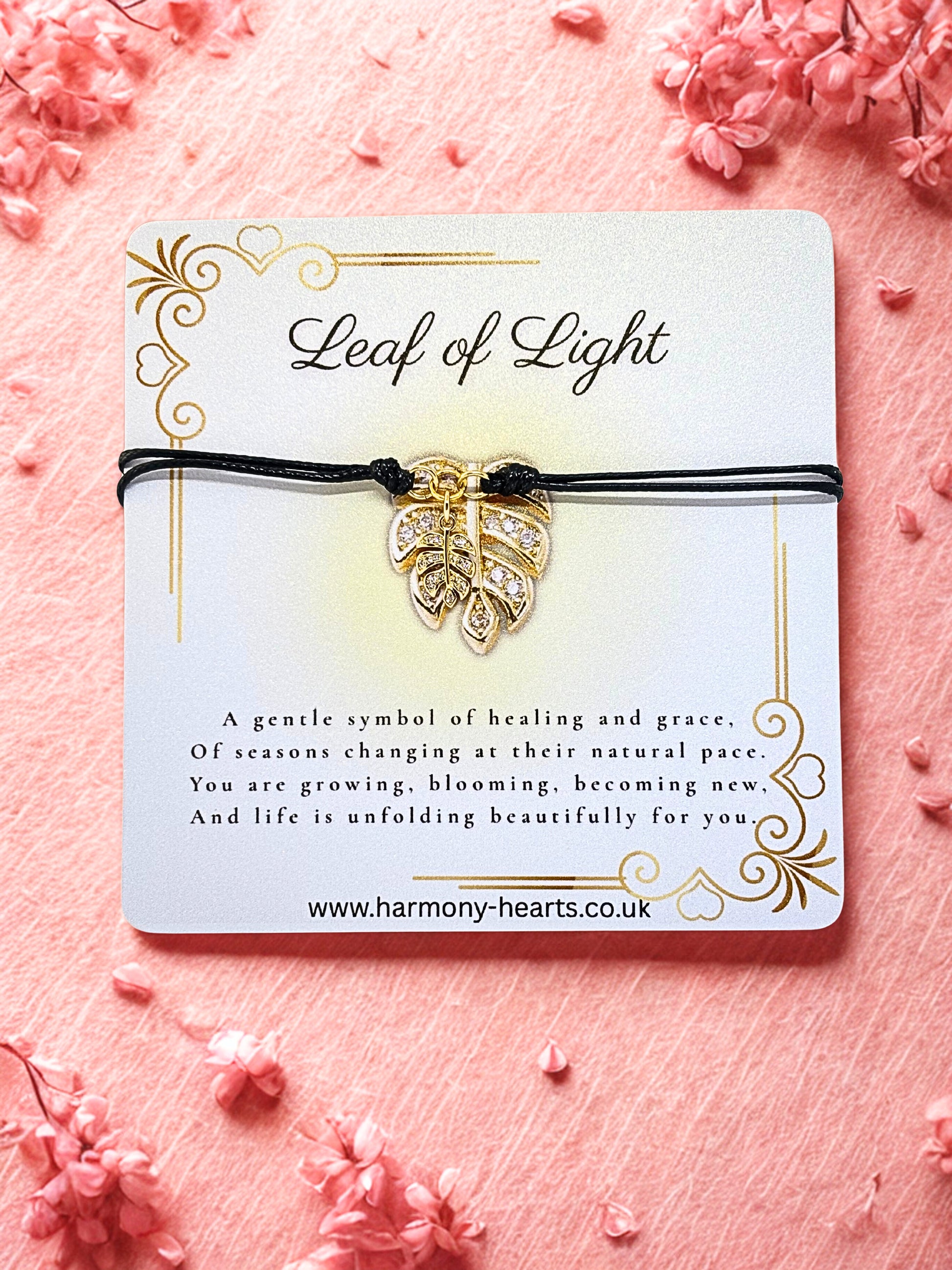 Bracelet with leaf design on a 'Leaf of Light' card against a pink floral background