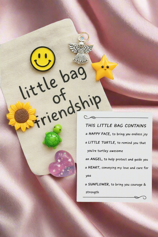 Little bag of friendship with decorative charms on a pink satin background