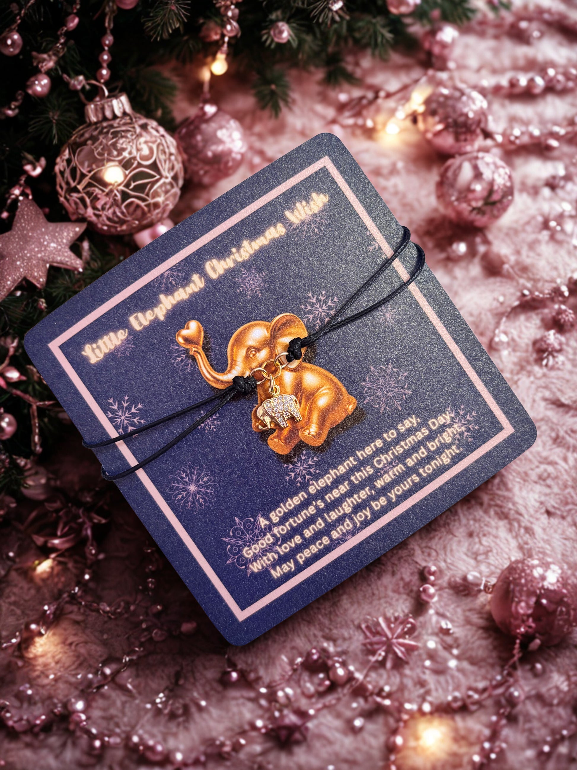 Gold elephant bracelet on a blue card with festive decorations
