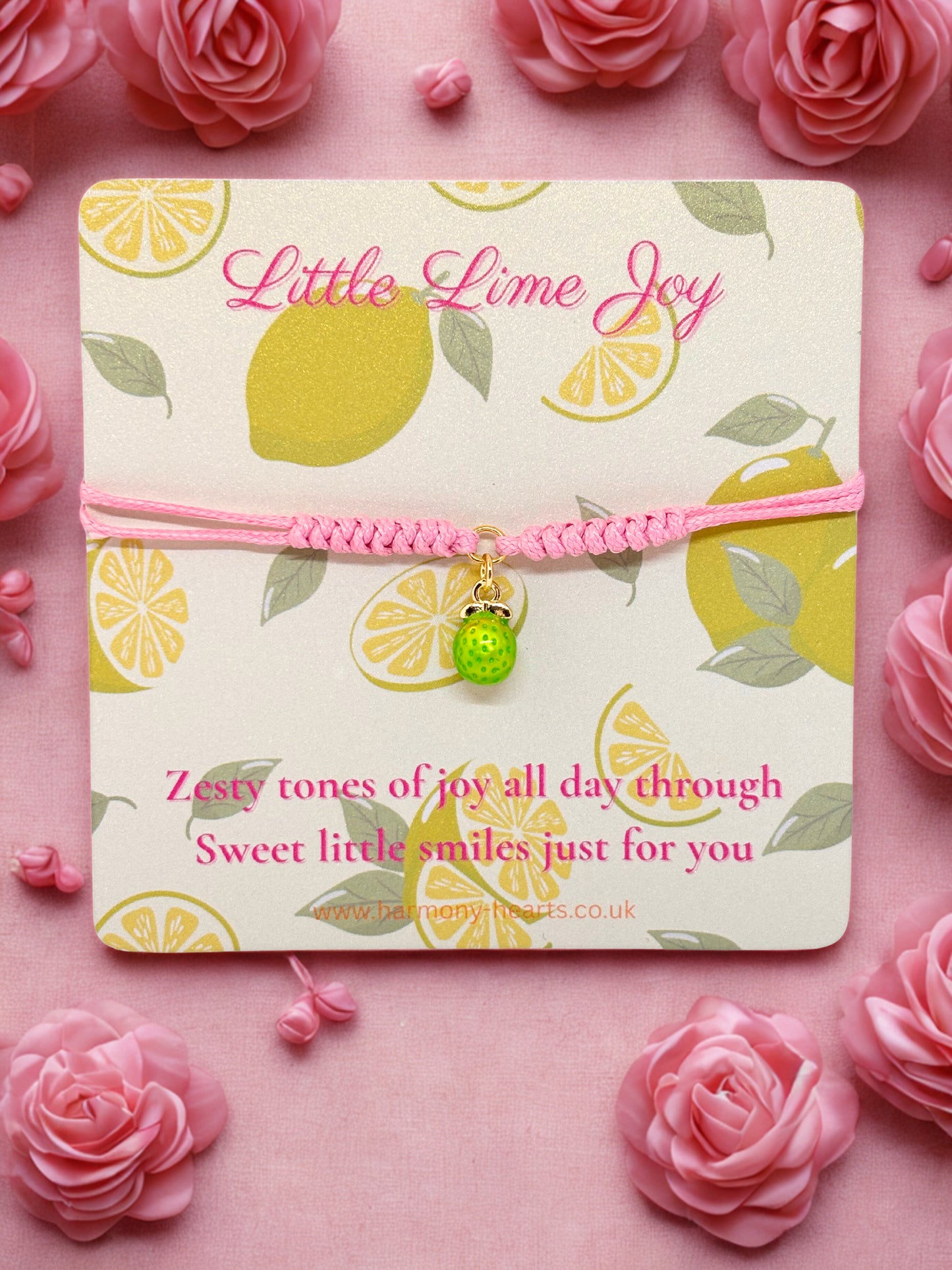 Pink cord bracelet with a lime charm presented on a Harmony Hearts branded card