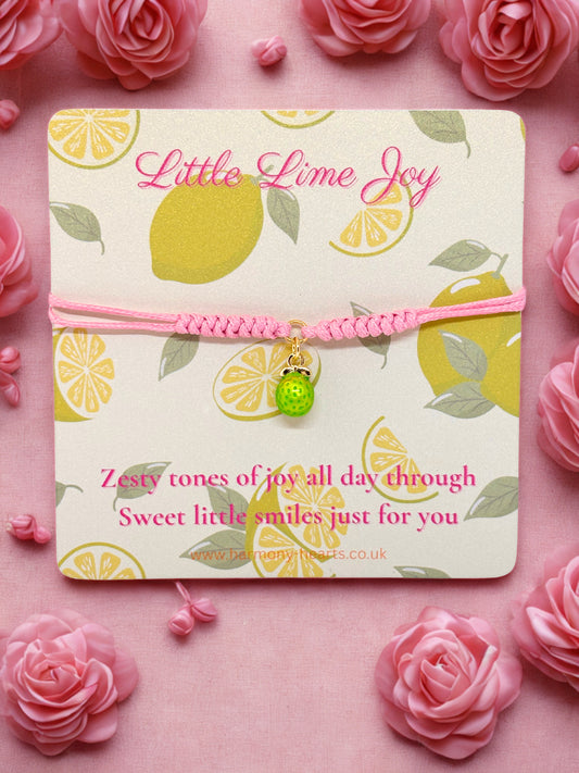 Pink cord bracelet with a lime charm presented on a Harmony Hearts branded card