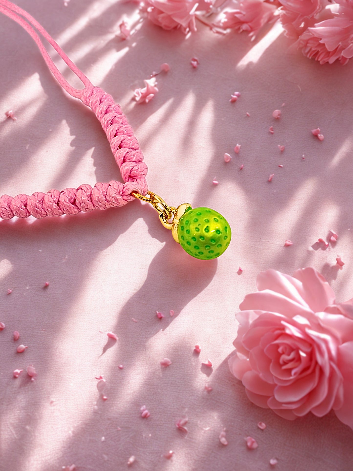 Pink cord bracelet with a lime charm