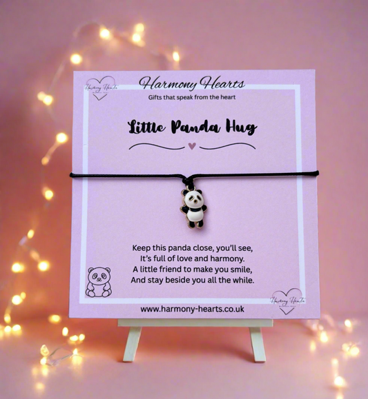 Panda charm bracelet on a stand with 'Harmony Hearts' branding against a pink background with string lights.