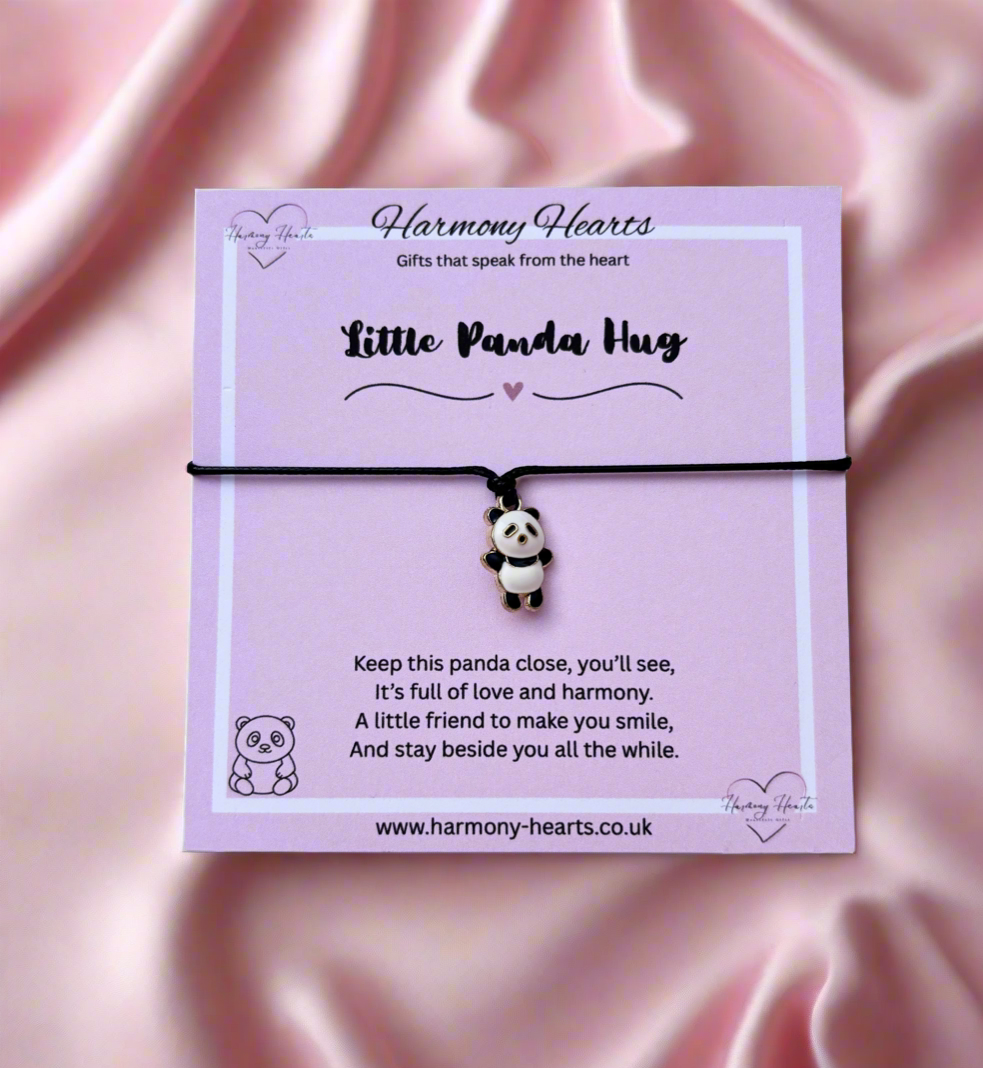 Panda charm bracelet on a pink satin background with 'Harmony Hearts' packaging.