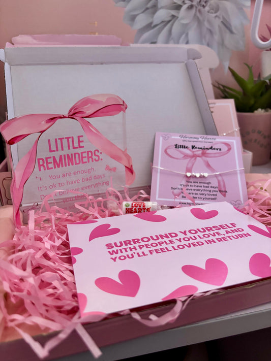 Pink-themed gift set with 'Little Reminders' product and motivational card.
