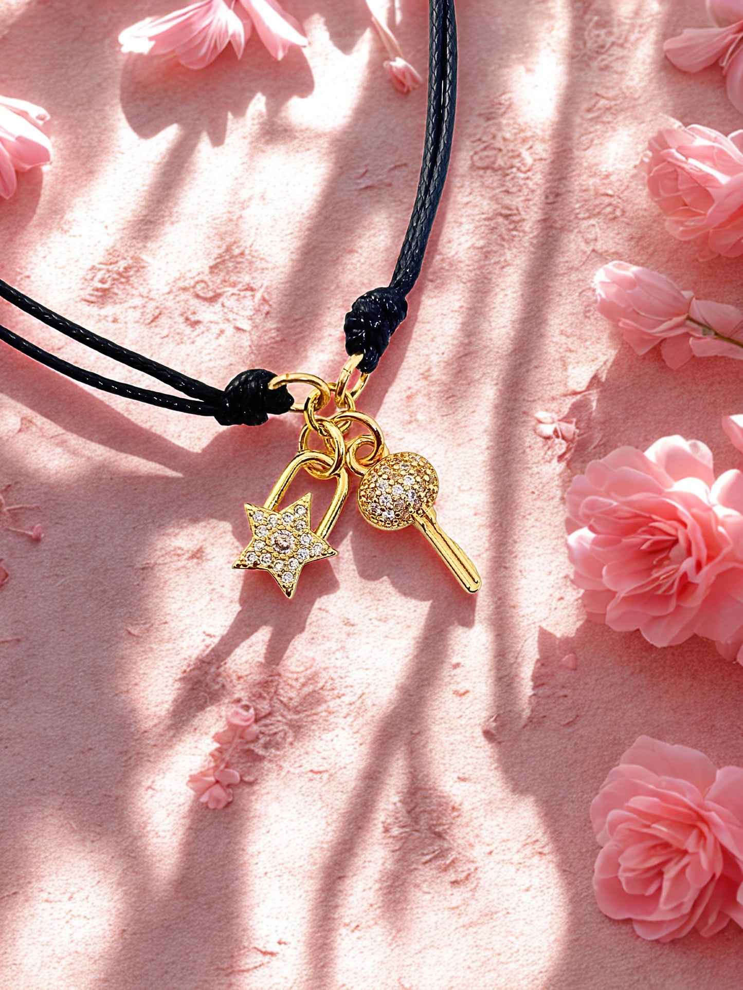 bracelet with star padlock and key charm on a pink floral background