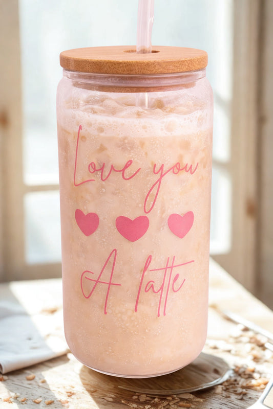 Glass of iced coffee with a straw and wooden lid, featuring 'Love you a latte' text.