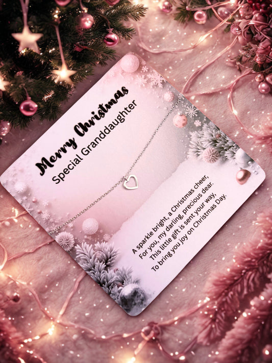 Silver heart bracelet on a card for a special granddaughter on Christmas with decorative elements.