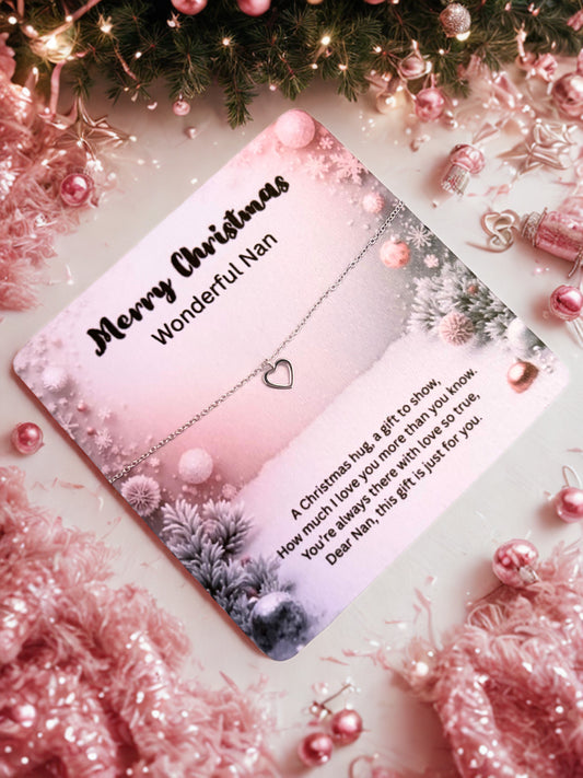 Silver heart bracelet on a Christmas card with 'Merry Christmas Wonderful Nan' text surrounded by festive decorations.