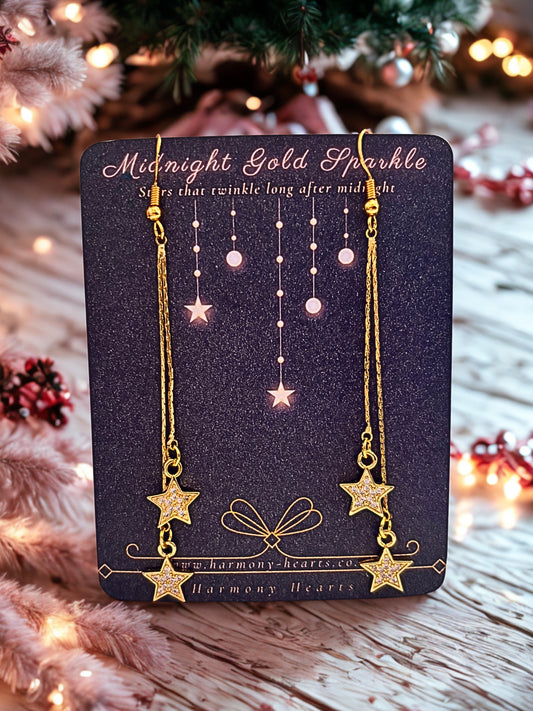 Gold drop earrings with sparkly stars on a Harmony Hearts branded card