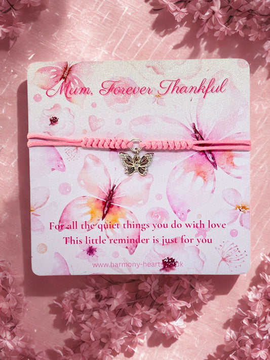 Pink bracelet with butterfly charm on a floral card with 'Mum, Forever Thankful' text.
