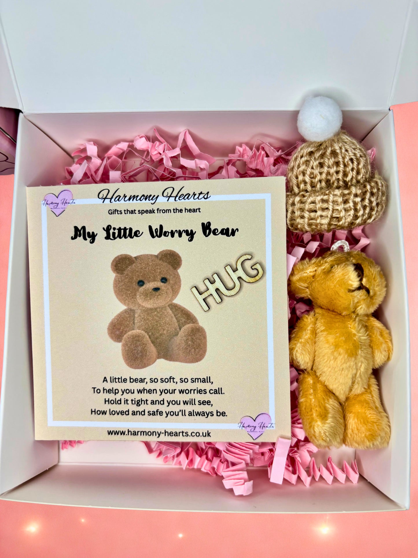 Small teddy bear with a card in a box labeled 'My Little Worry Bear HUG' by Harmony Hearts.