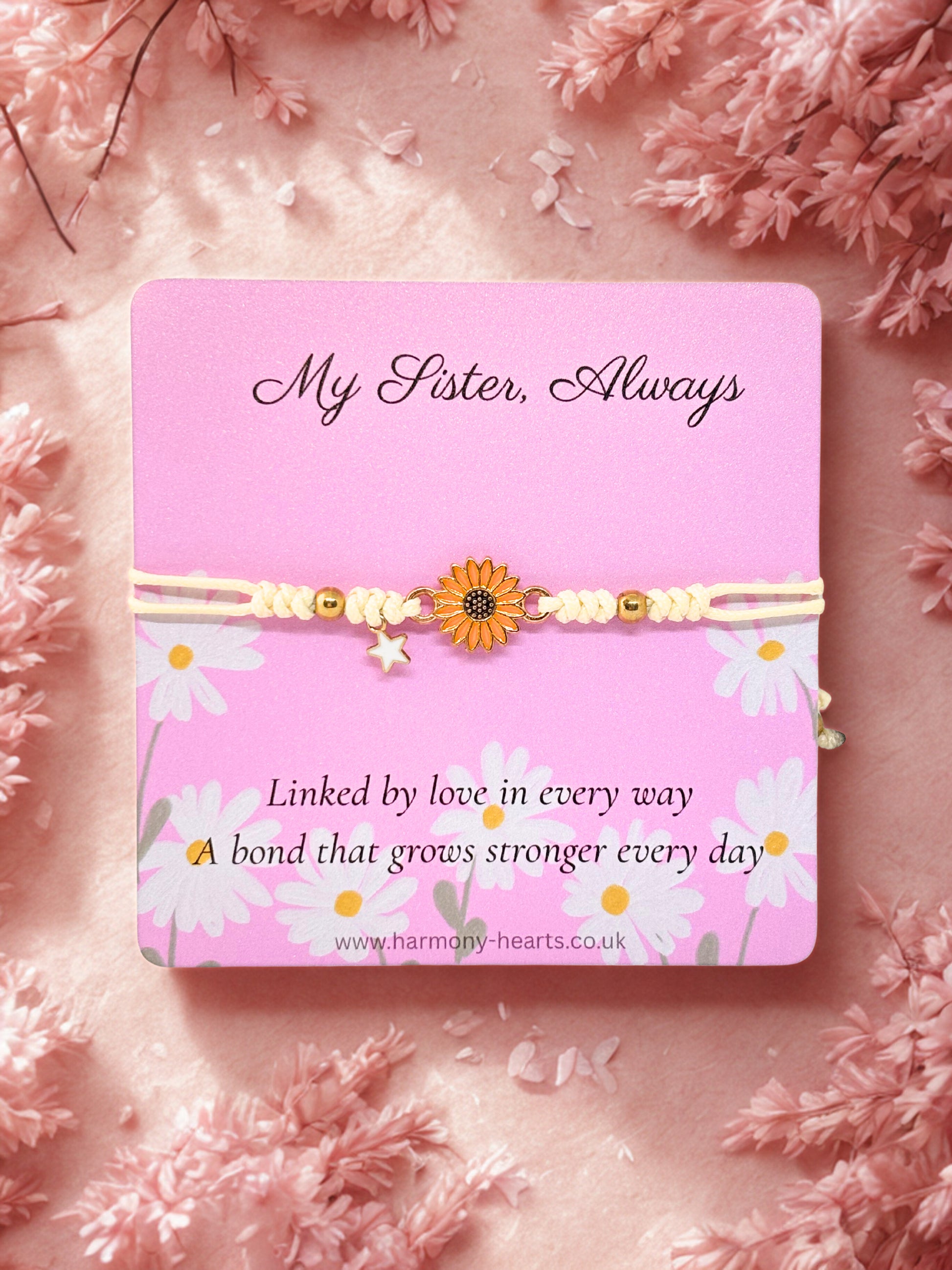 Pink Harmony Hearts branded card with daisy bracelet on a pink floral background